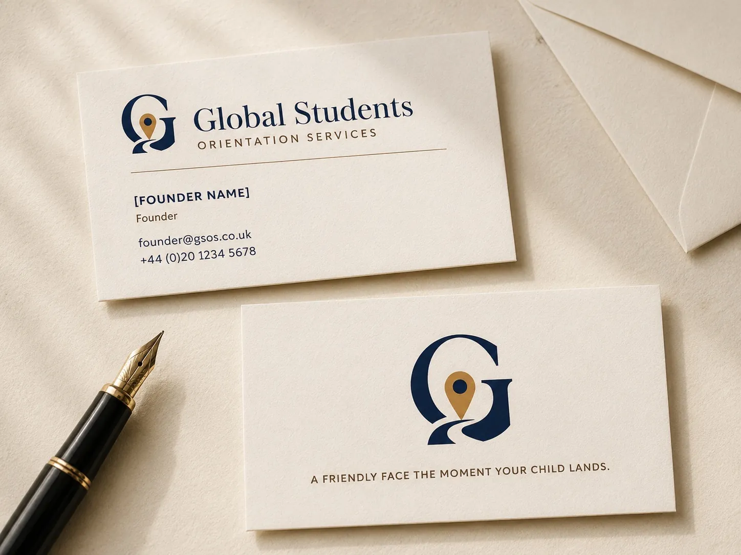 A pair of GSOS business cards — cream stock with the navy interlocking-G monogram, founder name, contact details, and the tagline 'A friendly face the moment your child lands.'
